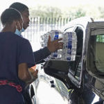 
              Recruits for the Jackson, Miss., Fire Department place cases of bottled water in a resident's car, Aug. 18, 2022, as part of the city's response to longstanding water system problems. On Monday, Aug. 29, 2022, Mississippi Gov. Tate Reeves said he's declaring a state of emergency after excessive rainfall worsened problems in one of Jackson’s already troubled water-treatment plants. (AP Photo/Rogelio V. Solis)
            