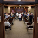 
              People gather in the Board of Supervisors hearing room to listen as Pinal County Board of Supervisors Chairman Jeffrey McClure and Pinal County Attorney Kent Volkmer address election day ballot shortages Pinal county, Wednesday, Aug. 3, 2022, in Florence, Ariz. (AP Photo/Matt York)
            