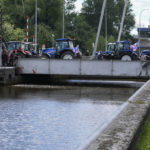 
              FILE - Protesting farmers block a draw bridge at a lock in the Princess Margriet canal, preventing all ship traffic from passing in Gaarkeuken, northern Netherlands, Monday, July 4, 2022. Representatives of Dutch farmers were meeting Friday, Aug. 5, 2022 with Prime Minister Mark Rutte and other Cabinet ministers to discuss the government's nitrogen emissions reduction goals that have sparked disruptive protests in recent weeks. (AP Photo/Peter Dejong, File)
            