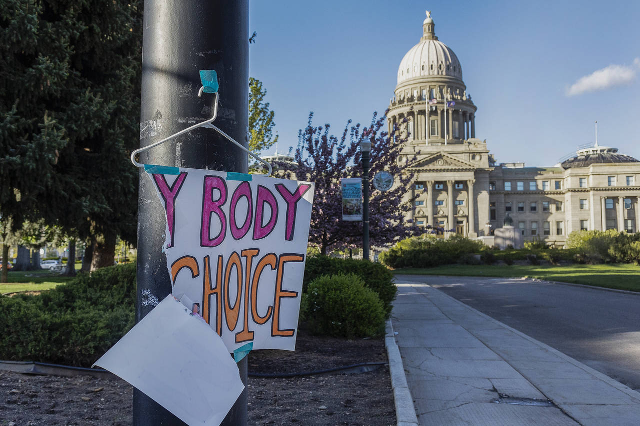 FILE - A sign reading "My body, my Choice," is taped to a hanger taped to a streetlight in front of...