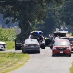 
              The area near Center and Smith roads was closed for hours during a standoff Thursday, Aug. 11, 2022, in Clinton County, Ohio, after an armed man tried to breach the FBI's Cincinnati office and fled north on te highway.  (Nick Graham/Dayton Daily News via AP)
            
