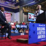 
              President Joe Biden speaks as Maryland Democratic gubernatorial candidate Wes Moore listens during a rally hosted by the Democratic National Committee at Richard Montgomery High School, Thursday, Aug. 25, 2022, in Rockville, Md. (AP Photo/Evan Vucci)
            