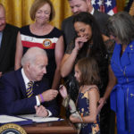 
              President Joe Biden gives the pen he used to sign the "PACT Act of 2022" to Brielle Robinson, daughter of Sgt. 1st Class Heath Robinson, who died of cancer two years ago, during a ceremony in the East Room of the White House, Wednesday, Aug. 10, 2022, in Washington. (AP Photo/Evan Vucci)
            