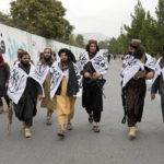 
              Taliban fighters celebrate one year since they seized the Afghan capital, Kabul, in front of the U.S. Embassy in Kabul, Afghanistan, Monday, Aug. 15, 2022. The Taliban marked the first-year anniversary of their takeover after the country's western-backed government fled and the Afghan military crumbled in the face of the insurgents' advance. (AP Photo/Ebrahim Noroozi)
            