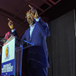 
              Democratic U.S. Sen. Raphael Warnock exhorts the crowd on Saturday, Aug. 27, 2022 at the Democratic Party of Georgia convention in Columbus, Ga. Warnock is seeking reelection to a full six-year term in November against candidates including Republican Herschel Walker. (AP Photo/Jeff Amy)
            