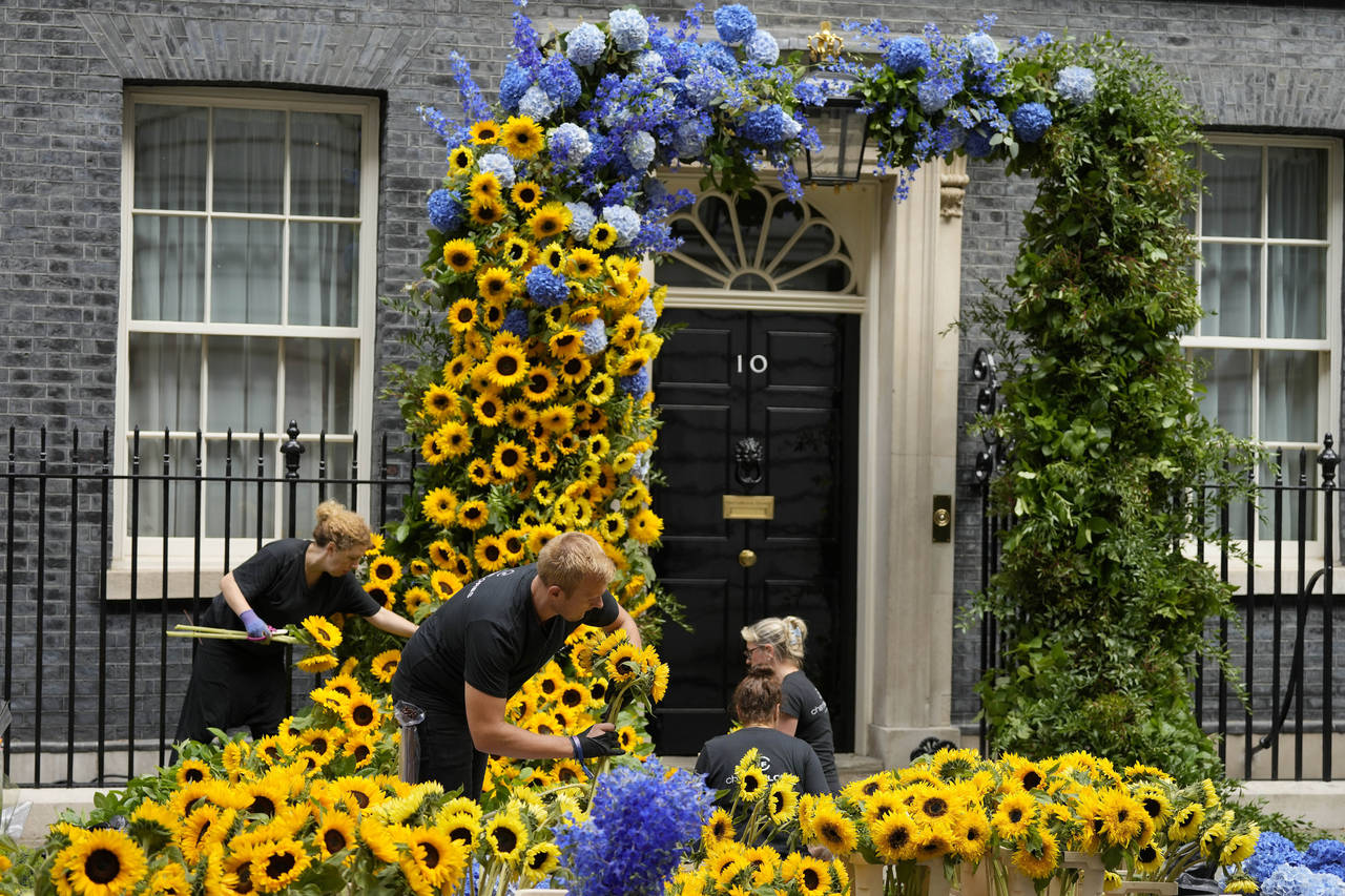 Florists prepare the entrance to 10 Downing Street with flowers in the Ukraine national colors in L...