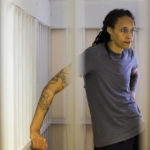 
              WNBA star and two-time Olympic gold medalist Brittney Griner, stands listening to a verdict in a courtroom in Khimki just outside Moscow, Russia, Thursday, Aug. 4, 2022. American basketball star Brittney Griner apologized to her family and teams as a Russian court heard closing arguments in her drug possession trial said it expected to deliver a verdict later Thursday. (Evgenia Novozhenina/Pool Photo via AP)
            