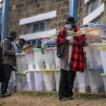 
              An electoral worker stands with ballot boxes lined up and ready to be stored at a collection and tallying center in Nairobi, Kenya Wednesday, Aug. 10, 2022. Kenyans are waiting for the results of a close but calm presidential election in which the turnout was lower than usual. (AP Photo/Ben Curtis)
            