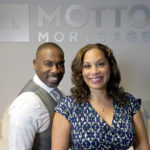 
              The husband and wife team of Kelly Jackson, left, and Davina Arceneaux sit for a portrait at their Motto Mortgage office Thursday, July 28, 2022, in Oakbrook Terrace, Ill. (AP Photo/Charles Rex Arbogast)
            