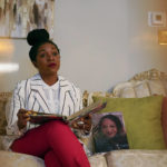 
              CORRECTS SPELLING FROM ONLEY TO OLNEY - Nikiesha Thomas' sister Keeda Simpson pauses as she looks through family photos in her mother's, Nadine Thomas, home in Olney, Md., Thursday, Aug. 25, 2022. Next to her on the sofa is a photo of Nikiesha, who was shot and killed by her ex-boy boyfriend just days after filing for a protective order, last October. Victims of abuse and their families saw a quiet breakthrough this summer when the passage of a bipartisan gun safety bill in Congress included a proposal that would make it more difficult for intimate partners of convicted domestic abusers to obtain firearms. (AP Photo/Carolyn Kaster)
            