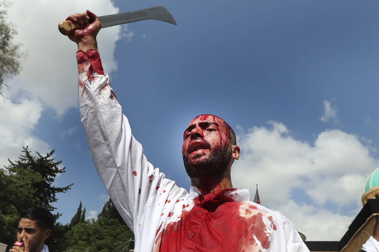 EDS NOTE: GRAPHIC CONTENT - A Lebanese Shiite man bleeds from self-inflicted head wounds, as he str...