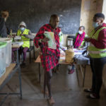 
              A Maasai man prepares to cast his vote in the general election at a polling station in Esonorua Primary School, in Kajiado County, Kenya Tuesday, Aug. 9, 2022. Polls opened Tuesday in Kenya's unusual presidential election, where a longtime opposition leader who is backed by the outgoing president faces the deputy president who styles himself as the outsider. (AP Photo/Ben Curtis)
            