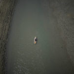 
              FILE - A paddle boarder passes through a drying portion of the Verdon Gorge in southern France, Tuesday, Aug. 9, 2022. France was in the midst of its fourth heat wave of the year Monday as the country faces what the government warned is its worst drought on record. (AP Photo/Daniel Cole, File)
            