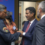 
              Muhammad Imtiaz Hussain, center, thanks Albuquerque Police Chief Harold Medina, left, following a news conference, Tuesday, Aug. 9, 2022, to announce the arrest of Muhammad Syed, a suspect in the recent killings of Muslim men in Albuquerque, N.M. Hussain's brother Muhammad Afzaal Hussain was killed on Aug. 1. At right is Bernalillo County District Attorney Raul Torres. (Adolphe Pierre-Louis/The Albuquerque Journal via AP)
            