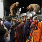 
              Army troops distribute food and other stuff to displace people in a flood-hit area in Rajanpur, district of Punjab, Pakistan, Saturday, Aug. 27, 2022. Officials say flash floods triggered by heavy monsoon rains across much of Pakistan have killed nearly 1,000 people and displaced thousands more since mid-June. (AP Photo/Asim Tanveer)
            