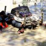 
              Displaced people float belongings salvaged from flood-hit homes through a flooded area, on the outskirts of Peshawar, Pakistan, Sunday, Aug. 28, 2022. Officials in Pakistan say deaths from widespread flooding have topped 1,000 since mid-June. Flash flooding from the heavy rains has washed away villages and crops as soldiers and rescue workers evacuated stranded residents to the safety of relief camps and provided food to thousands of displaced Pakistanis. (AP Photo/Mohammad Sajjad)
            