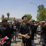 
              Supporters of Iraqi Shiite cleric Muqtada al-Sadr protest in front the Supreme Judicial Council, in Baghdad, Iraq, Tuesday, Aug. 23, 2022. Dozens of supporters of al-Sadr, an influential Shiite cleric in Iraq, rallied on Tuesday in Baghdad’s heavily-fortified Green Zone, demanding the dissolution of parliament and early elections. The demonstration underscored how intractable Iraq's latest political crisis has become. (AP Photo/Hadi Mizban)
            