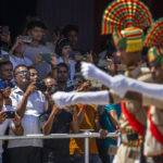 
              People take photographs on their mobile phones as Assam police battalion personnel take part in the parade on Independence Day in Gauhati, in the northeastern state of Assam, India, Monday, Aug. 15, 2022. The country is marking the 75th anniversary of its independence from British rule. (AP Photo/Anupam Nath)
            