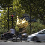 
              A car drives past the gilded statue modeled on the flame of the Statue of Liberty that serves as an unofficial shrine to Princess Diana,  in Paris, Monday Aug. 22, 2022, It has been nearly 25 years since Princess Diana died in a high-speed car crash in Paris. The French doctor who treated her at the scene has recounted what happened. Dr. Frederic Mailliez told The Associated Press how he tried to save her on that night of Aug. 31, 1997. The Flame of Liberty monument nearby has become a memorial site attracting fans of all generations and nationalities. (AP Photo/Aurelien Morissard)
            