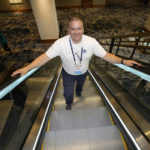 
              Student resource officer Tony Ramaeker, from Elkhorn, Neb., heads up an escalator while attending a convention, Tuesday, July 5, 2022, in Denver. (AP Photo/David Zalubowski)
            