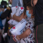 
              Children who arrived off a bus from Arizona with their families hold blankets from the American Red Cross, as they listen to instructions from the nonprofit, SAMU First Response, as asylum seekers from Latin America and Haiti arrive on a bus sent to Washington from Arizona, Thursday, Aug. 11, 2022, at a church on Capitol Hill in Washington. (AP Photo/Jacquelyn Martin)
            