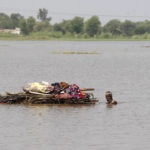 
              A displaced man transports usable belongings salvaged from his flood-hit home across a flooded area in the Shikarpur district of Sindh province, Pakistan, Tuesday, Aug. 30, 2022. Disaster officials say nearly a half million people in Pakistan are crowded into camps after losing their homes in widespread flooding caused by unprecedented monsoon rains in recent weeks. (AP Photo/Fareed Khan)
            