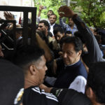 
              Former Pakistani Prime Minister Imran Khan, center, arrives to an anti-terrorism court in Islamabad, Pakistan, Thursday, Aug. 25, 2022. The court on Thursday extended former premier Imran Khan's protection from arrest through the end of the month, officials said, after police filed terrorism charges against the country's popular opposition leader. (AP Photo/W.K. Yousafzai)
            