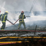 
              Firefighters work to put out a deadly fire at a large oil storage facility in Matanzas, Cuba, Tuesday, Aug. 9, 2022. The fire was triggered when lighting struck one of the facility's eight tanks late Friday, Aug. 5th. (Yamil Lage, Pool photo via AP)
            