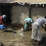 
              A family remove flood water from their home after heavy rains in the Shikarpur district of Sindh province, Pakistan, Tuesday, Aug. 30, 2022. Disaster officials say nearly a half million people in Pakistan are crowded into camps after losing their homes in widespread flooding caused by unprecedented monsoon rains in recent weeks. (AP Photo/Fareed Khan)
            