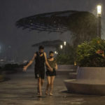 
              People walks on the promenade of Victoria Habour as tropical cyclone Ma-on approaches Hong Kong, Wednesday, Aug. 24, 2022. Tropical Storm Ma-on was gaining strength as it headed for Hong Kong and other parts of southeastern China on Wednesday after displacing thousands in the Philippines. (AP Photo/Anthony Kwan)
            