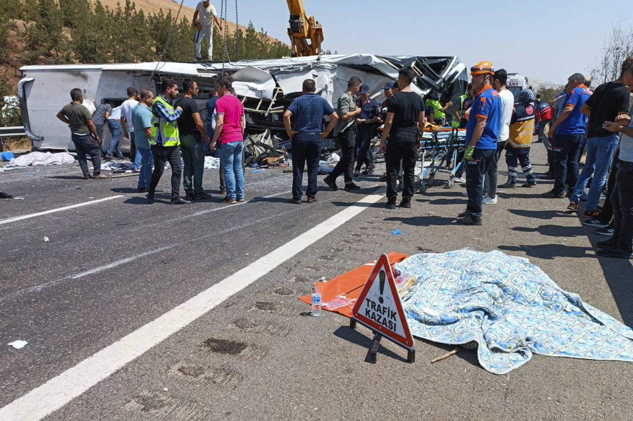 Emergency and rescue teams attend the scene after a bus crash accident on the highway between Gazia...