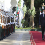 
              French President Emmanuel Macron, right, reviews the troops before his talks with Algerian President Abdelmajid Tebboune, Thursday, Aug. 25, 2022 in Algiers. French President Emmanuel Macron is in Algeria for a three-day official visit aimed at addressing two major challenges: boosting future economic relations while seeking to heal wounds inherited from the colonial era, 60 years after the North African country won its independence from France. (AP Photo/Anis Belghoul)
            