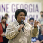 
              FILE - Georgia gubernatorial candidate Stacey Abrams answers questions from the crowd as she speaks during a visit to the Mack Gaston Community Center in Dalton, Ga., Friday, July 29, 2022. On Monday, Aug. 15, 2022, Abrams accused Republican Gov. Brian Kemp of trying to buy votes with a plan to make $350 payments to more than 3 million Georgians who benefit from Medicaid, subsidized child health insurance, food stamps or cash welfare. (Matt Hamilton/Chattanooga Times Free Press via AP, File)
            