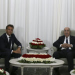 
              French President Emmanuel Macron, left, pose with Algerian President Abdelmajid Tebboune before their talks, Thursday, Aug. 25, 2022 in Algiers. French President Emmanuel Macron is in Algeria for a three-day official visit aimed at addressing two major challenges: boosting future economic relations while seeking to heal wounds inherited from the colonial era, 60 years after the North African country won its independence from France. (AP Photo/Anis Belghoul)
            
