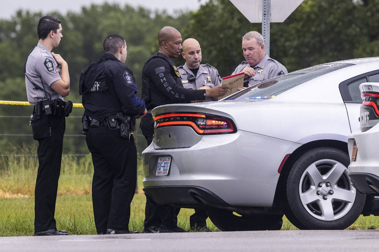 Wake County Sheriff deputies work at the scene where a deputy was shot and killed in eastern Wake C...