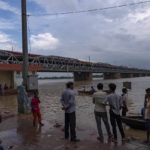 
              People stand watching the rising water level of the River Yamuna after heavy rainfall in Prayagraj, in the northern Indian state of Uttar Pradesh, Saturday, Aug. 20, 2022. AP Photo/Rajesh Kumar Singh)
            