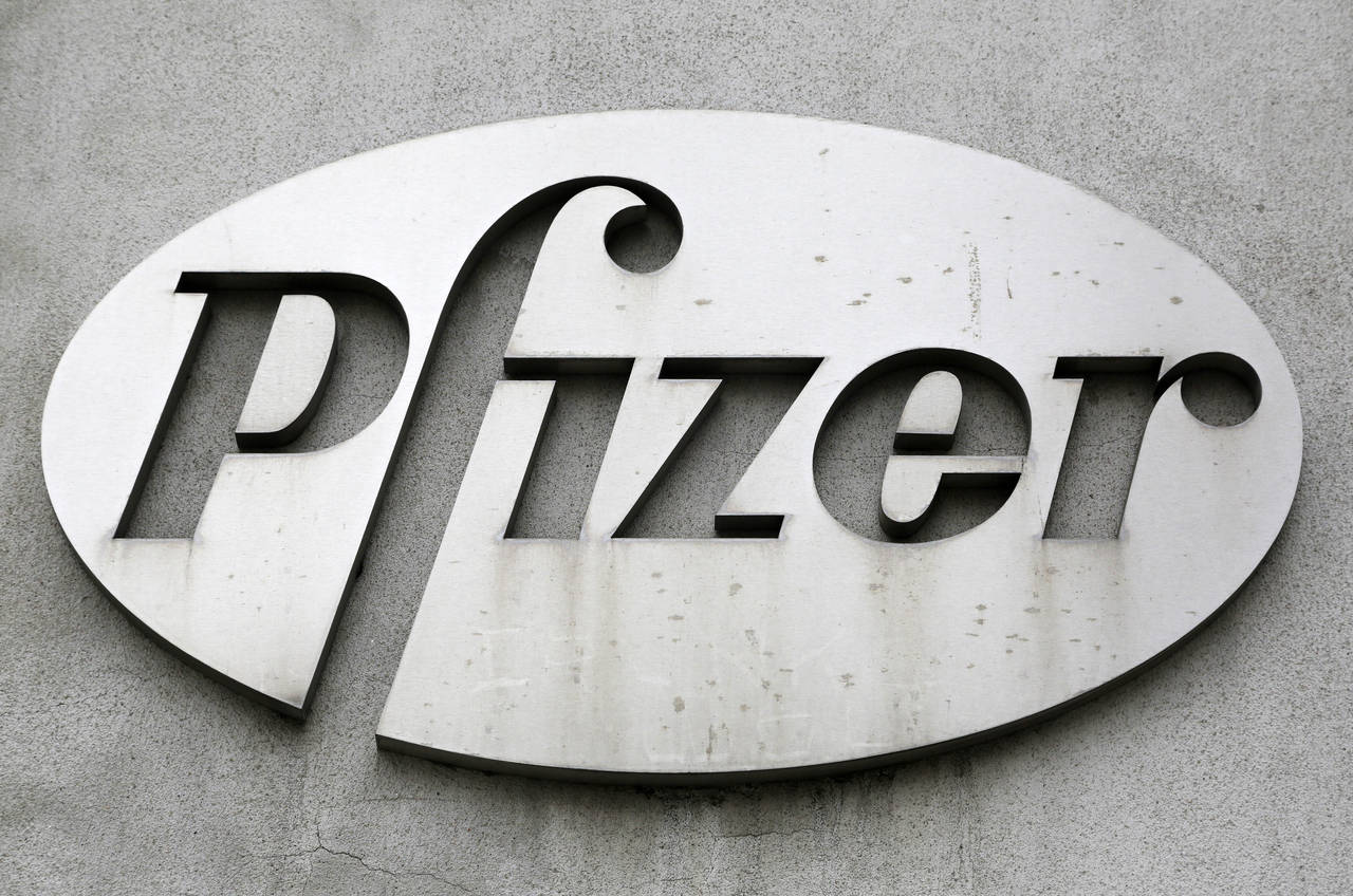 FILE - The Pfizer logo is displayed on the exterior of a former Pfizer factory, on May 4, 2014, in ...