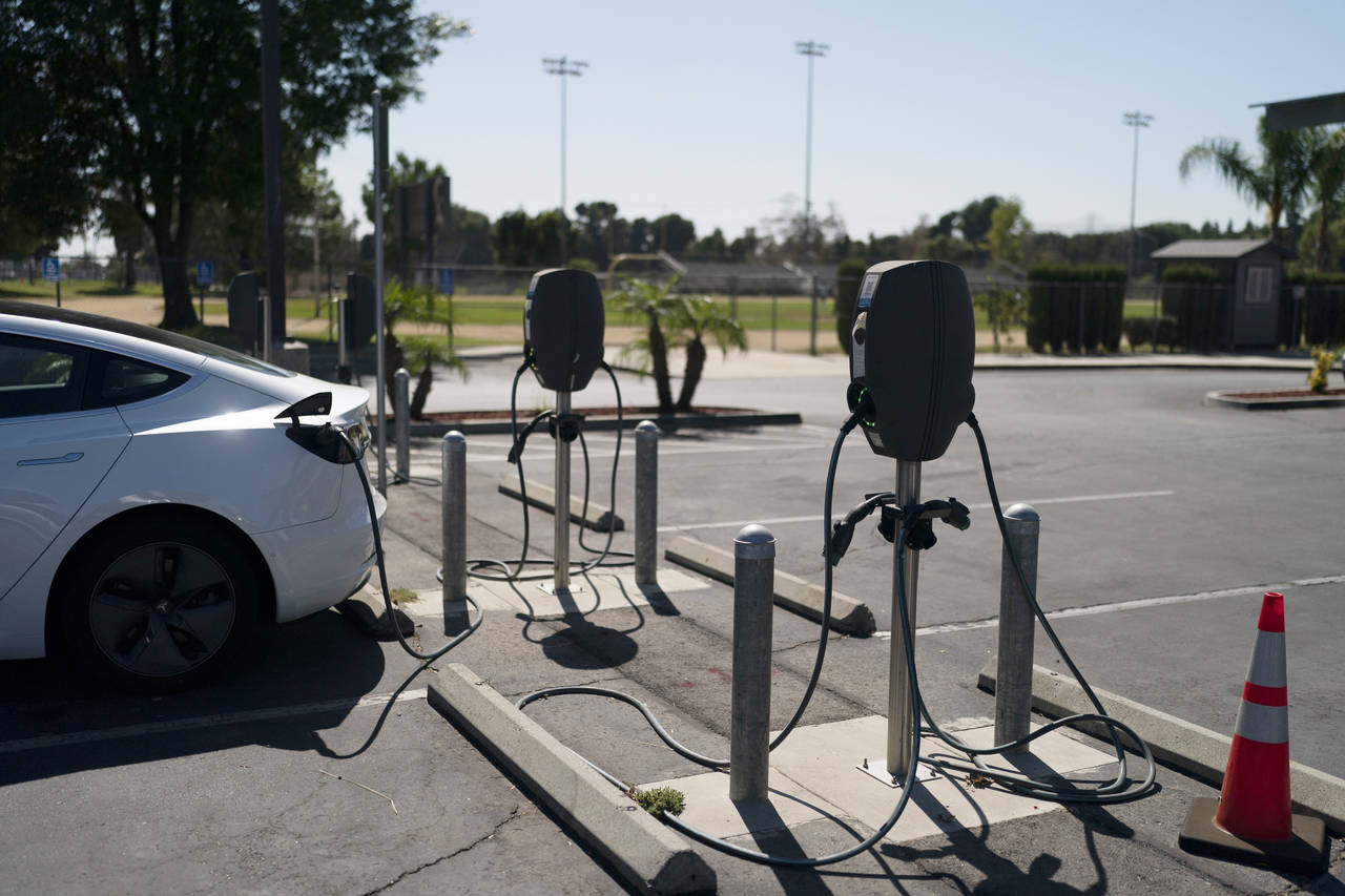 Electric vehicle chargers are seen in the parking lot of South El Monte High School in South El Mon...