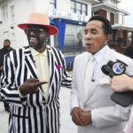 
              Original Temptation Otis Williams, left, and Smokey Robinson speak in front of the Motown Museum during a celebration for the completion of two of three phases of an ambitious expansion plan for the museum, including a new square/courtyard in front of the property, in Detroit, Monday, Aug. 8, 2022. (Daniel Mears/Detroit News via AP)
            