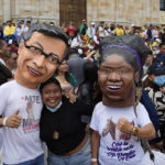 
              Supporters of new President Gustavo Petro, wearing masks of him and new Vice-President Francia Marquez, right, wait for their swearing-in ceremony at the Bolivar square in Bogota, Colombia, Sunday, Aug. 7, 2022. (AP Photo/Ariana Cubillos)
            