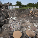 
              Destroyed houses after a Russian attack are seen in the village Chaplyne, Ukraine, Thursday, Aug. 25, 2022. The death toll from a Russian rocket attack on a train station and the surrounding area as Ukraine celebrated its Independence Day climbed to 25, including at least two children, Ukrainian authorities said Thursday. Russia said it targeted a military train and claimed to have killed more than 200 Ukrainian reservists. (AP Photo/Inna Varenytsia)
            