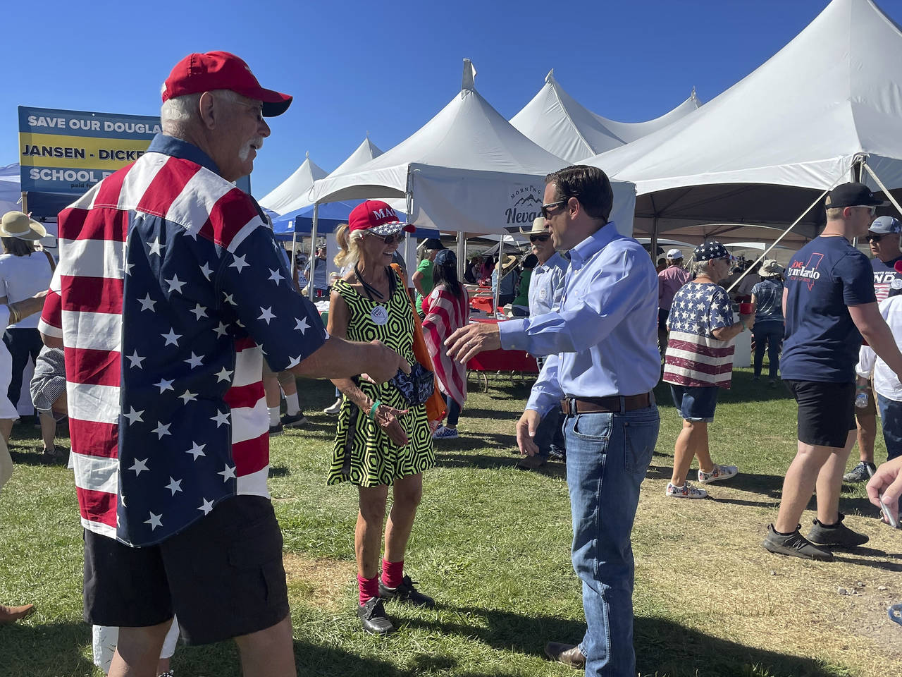 Republican Nevada Senate candidate Adam Laxalt, right, takes pictures with supporters at the sevent...