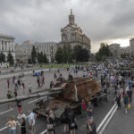 
              Ukrainians visit an avenue where destroyed Russian military vehicles have been displayed in Kyiv, Ukraine, Saturday, Aug. 20, 2022. Drawing the attention of large numbers of pedestrians and amateur snappers on Saturday in downtown Kyiv a large column of burned out and captured Russian tanks and infantry carriers were displayed on the central Khreshchatyk boulevard. (AP Photo/Andrew Kravchenko)
            