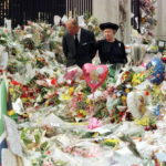 
              FILE - Britain's Queen Elizabeth II and Prince Philip view the floral tributes to Diana, Princess of Wales, at London's Buckingham Palace, Friday, Sept. 5, 1997.  Above all, there was shock. That’s the word people use over and over again when they remember Princess Diana’s death in a Paris car crash 25 years ago this week. The woman the world watched grow from a shy teenage nursery school teacher into a glamorous celebrity who comforted AIDS patients and campaigned for landmine removal couldn’t be dead at the age of 36, could she? (Pool Photo via AP, File)
            