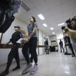 
              WNBA star and two-time Olympic gold medalist Brittney Griner is escorted from a court room ater a hearing, in Khimki just outside Moscow, Russia, Thursday, Aug. 4, 2022. A judge in Russia has convicted American basketball star Brittney Griner of drug possession and smuggling and sentenced her to nine years in prison. (AP Photo/Alexander Zemlianichenko)
            