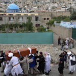 
              Mourners carry the body of a victim of a mosque bombing in Kabul, Afghanistan, Thursday, Aug. 18. 2022. A bombing at a mosque in Kabul during evening prayers on Wednesday killed at least 10 people, including a prominent cleric, and wounded over two dozen, an eyewitness and police said. (AP Photo/Ebrahim Noroozi)
            