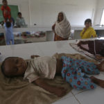 
              Displaced families take refuge in a government college building after fleeing their flood-hit homes, in Karachi, Pakistan, Monday, Aug. 29, 2022. International aid was reaching Pakistan on Monday, as the military and volunteers desperately tried to evacuate many thousands stranded by widespread flooding driven by "monster monsoons" that have claimed more than 1,000 lives this summer. (AP Photo/Fareed Khan)
            