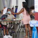 
              Polling workers assisting a voters during the Florida primary election at the Miami Beach Fire Department - Station 3 on Tuesday, Aug. 23, 2022 in Miami Beach, Fla. (David Santiago /Miami Herald via AP)
            