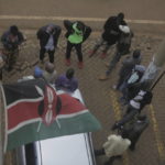 
              People wait for results outside a polling station in Eldoret, Kenya, Wednesday Aug. 10, 2022. Kenyans voted to choose between opposition leader Raila Odinga Deputy President William Rutoto succeed President Uhuru Kenyatta after a decade in power. (AP Photo/Brian Inganga)
            