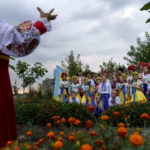 
              Members of a local community center wear traditional Ukrainian clothing to record an online video message for the country's upcoming Independence Day on Aug. 24 in Andriivka, Donetsk region, eastern Ukraine, Friday, Aug. 19, 2022. (AP Photo/David Goldman)
            